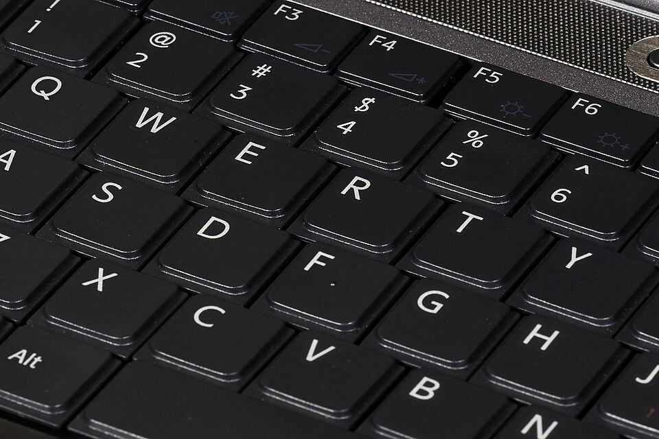 Close-up of the keys of a laptop's built-in keyboard; the keys are raised by a relatively small height
