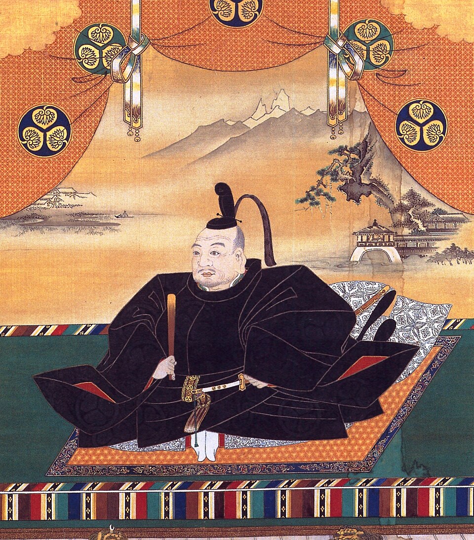 Tableau représentant un homme asiatique médiéval assis et vêtu avec splendeur