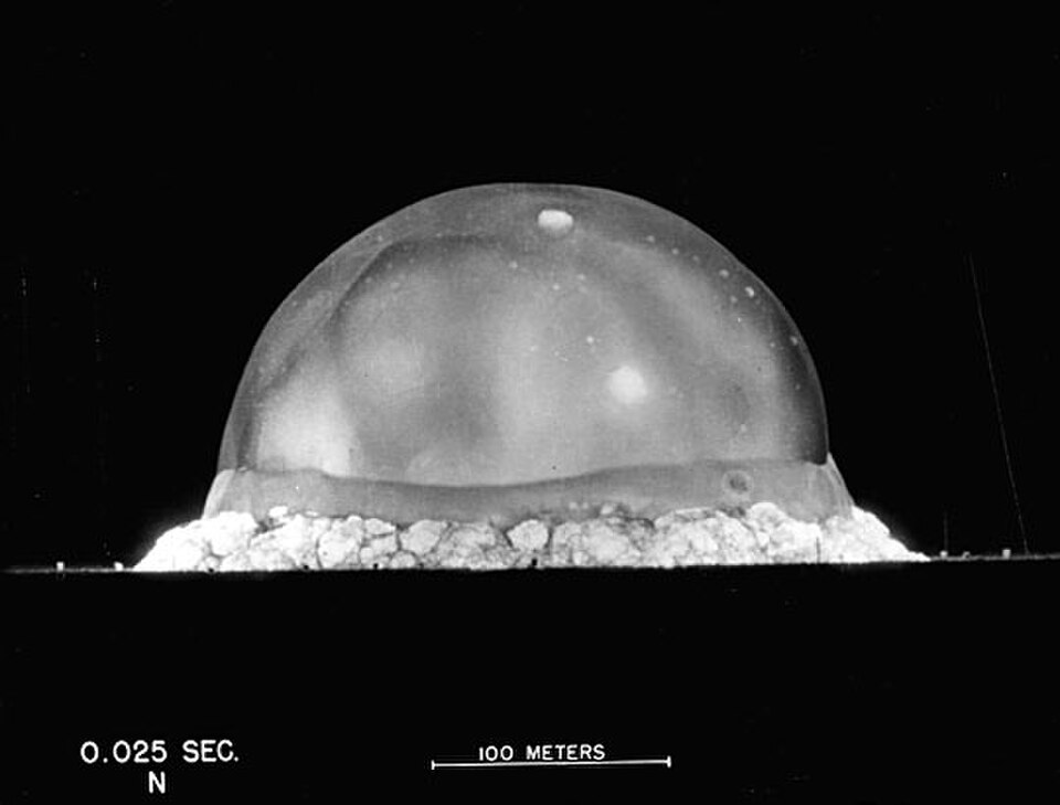 L'explosion de Trinity, 25 ms après la détonation. Le point le plus élevé de l'hémisphère de la boule de feu observé sur cette image est à environ 200 mètres (660 pieds) de hauteur.