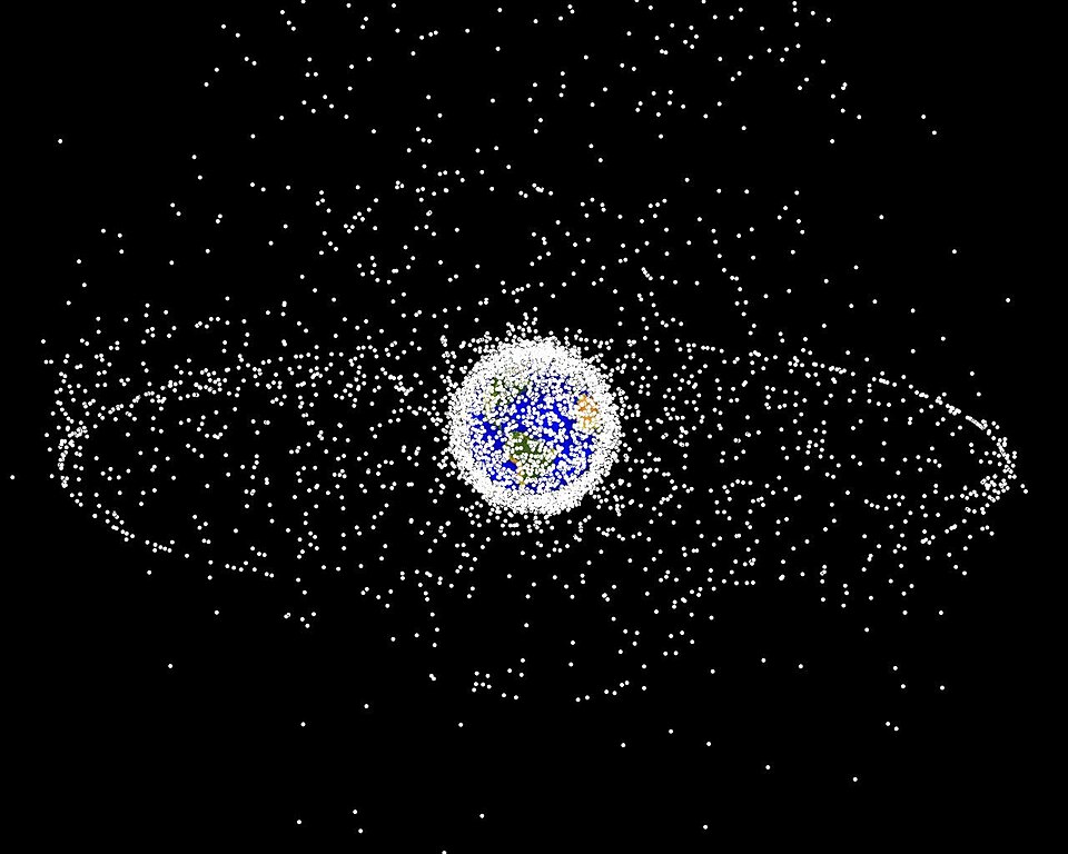 La Terre vue de l'espace, entourée de petits points blancs