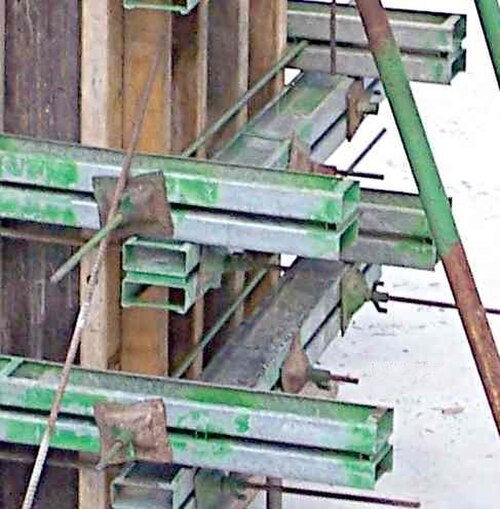 Des lisses doubles en acier et des boulons d'ancrage sont utilisés pour fixer les coffrages muraux