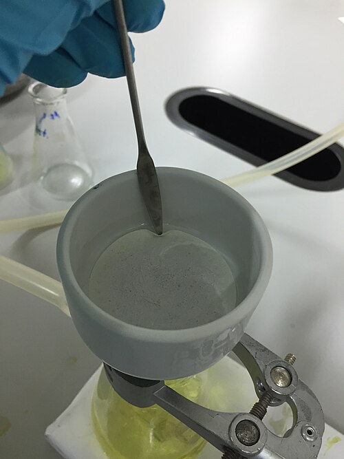 C'est l'une des nombreuses utilisations de la spatule en acier inoxydable : elle peut être utilisée pour faciliter le retrait du papier filtre de la filtration sous vide.